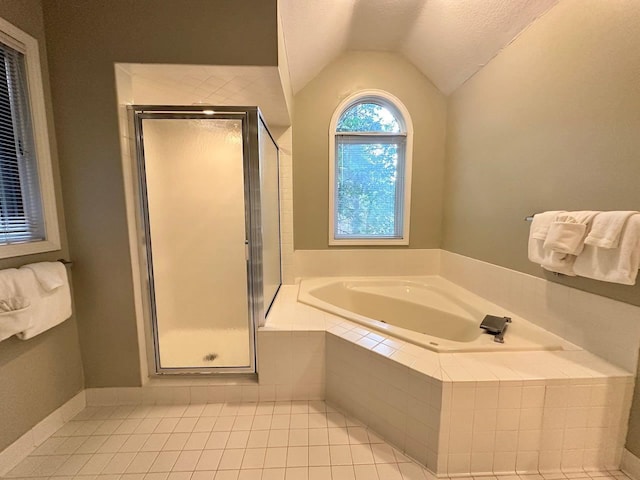 bathroom with lofted ceiling, tile patterned flooring, and plus walk in shower