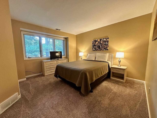 bedroom with dark colored carpet