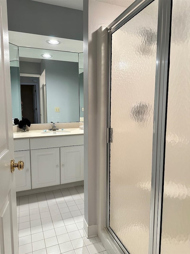 bathroom featuring vanity, tile patterned floors, and walk in shower