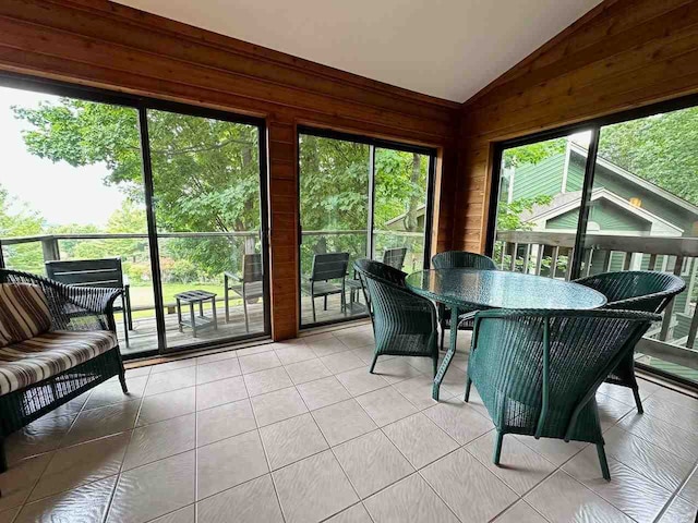 sunroom featuring vaulted ceiling