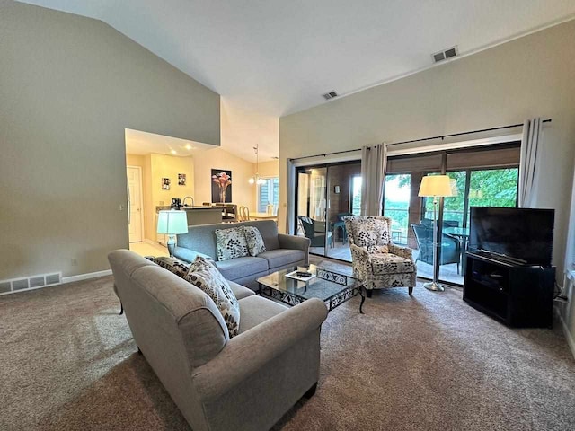 living room with carpet flooring and vaulted ceiling