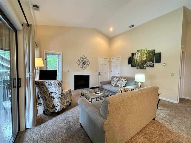 living room with high vaulted ceiling and carpet flooring