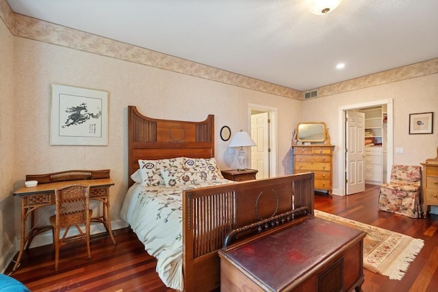 bedroom with visible vents and wood finished floors