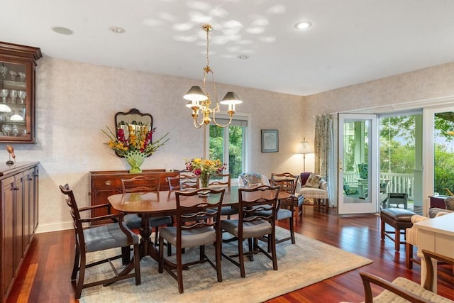 dining room featuring a chandelier, recessed lighting, dark wood-type flooring, and baseboards