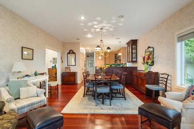 dining space with recessed lighting, an inviting chandelier, and dark wood-style flooring