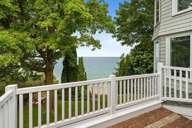 wooden terrace featuring a water view