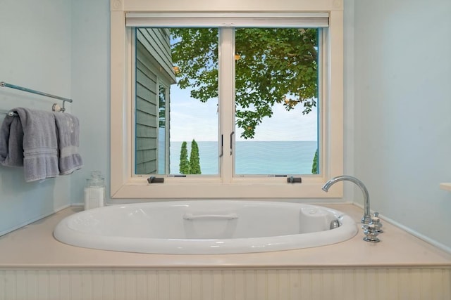 full bath with a garden tub and a healthy amount of sunlight