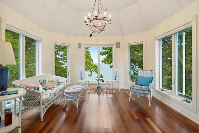 sunroom / solarium with a notable chandelier and vaulted ceiling