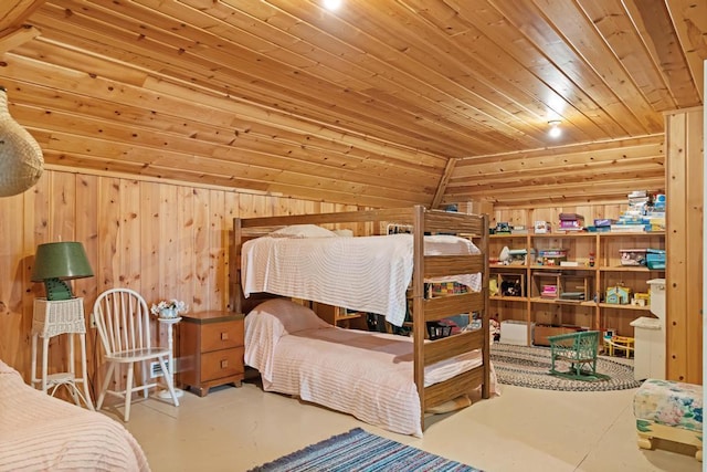 bedroom featuring lofted ceiling, wooden walls, wooden ceiling, and concrete floors