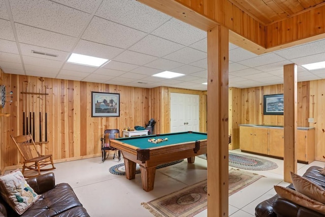 recreation room with a drop ceiling, visible vents, wooden walls, and billiards