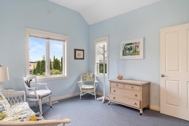 living area with vaulted ceiling, carpet, and baseboards