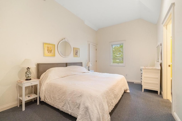 bedroom featuring baseboards, lofted ceiling, and dark carpet