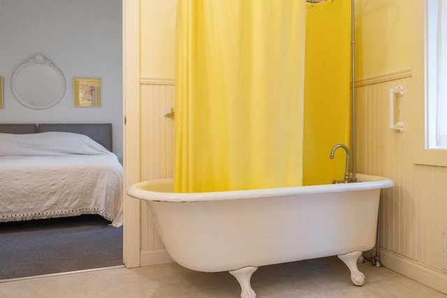 full bathroom with tile patterned floors and a freestanding tub