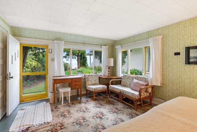 bedroom featuring baseboards and wallpapered walls