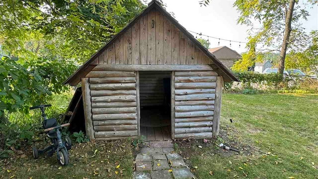 view of outbuilding with a yard