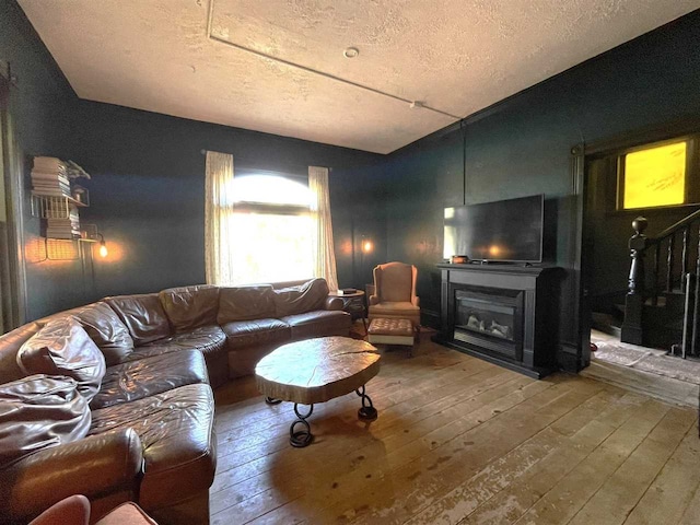 living room with a textured ceiling and hardwood / wood-style flooring