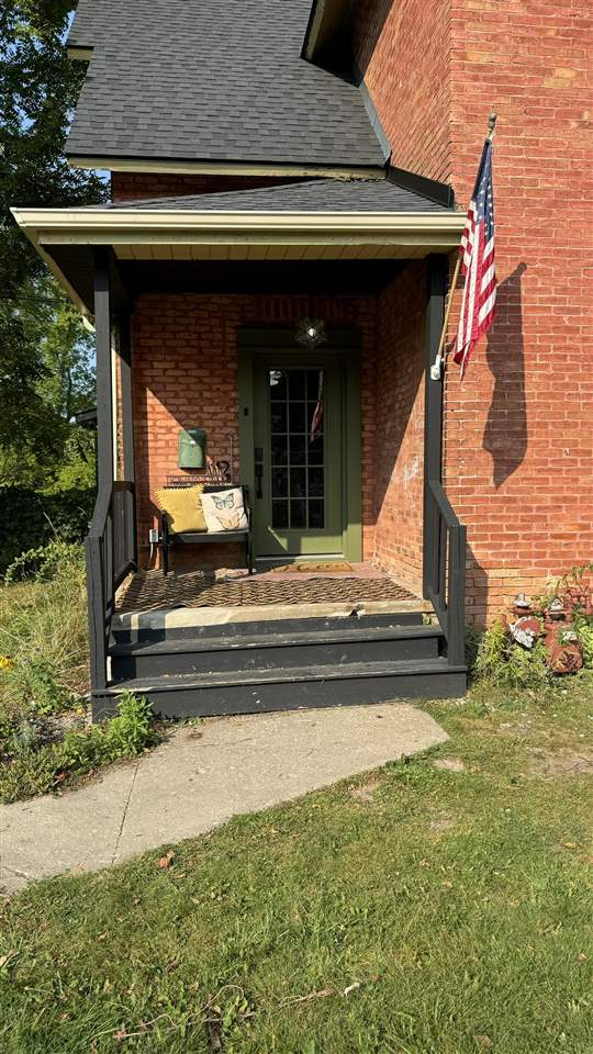 exterior space featuring a yard and covered porch