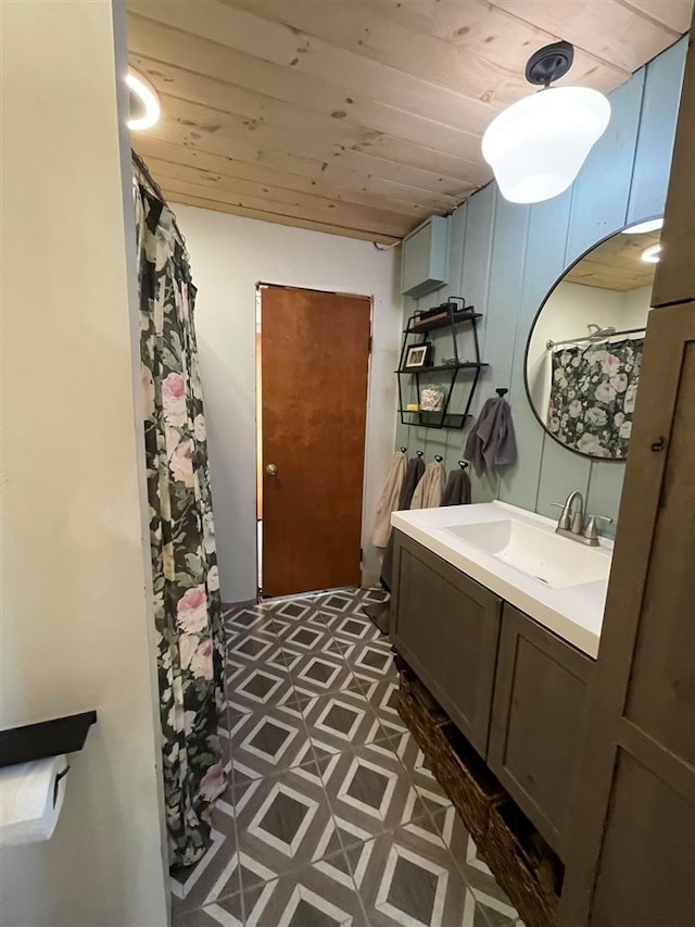 bathroom featuring wood-type flooring, vanity, and wooden ceiling