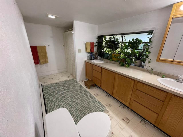 bathroom with vanity and toilet