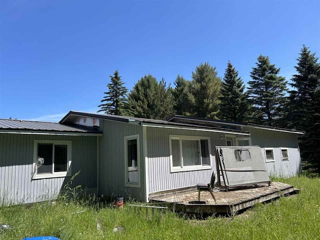 back of house with a wooden deck