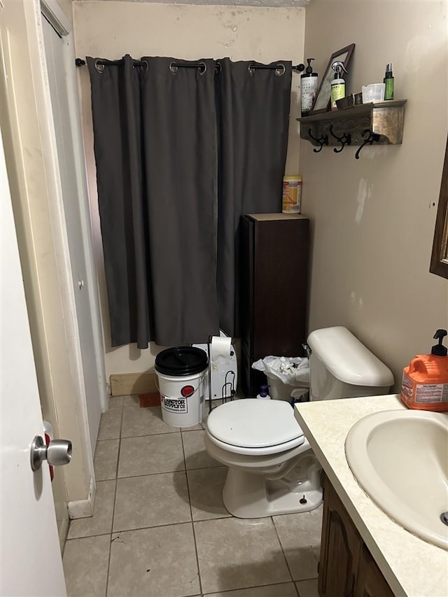 bathroom featuring vanity, toilet, and tile patterned floors