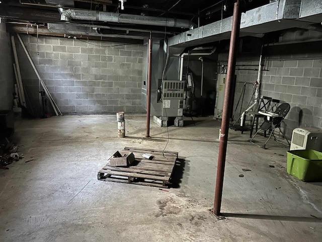 basement featuring gas water heater and heating unit