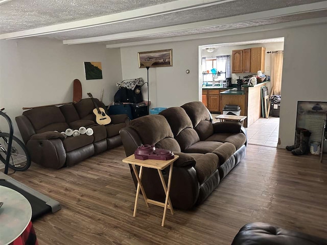 living room featuring a textured ceiling and hardwood / wood-style floors