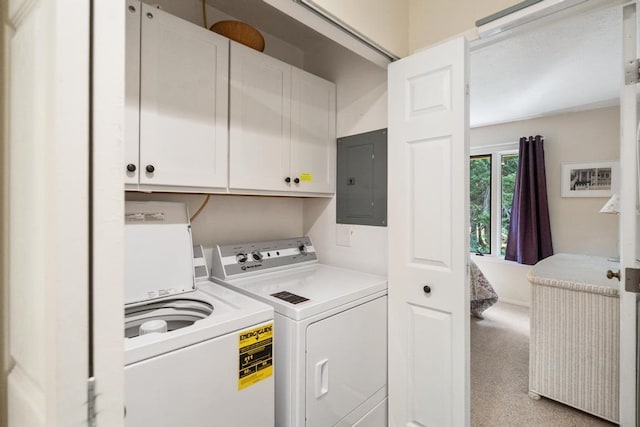 clothes washing area with cabinets, light carpet, electric panel, and washer and dryer