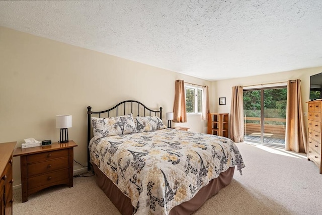 bedroom featuring a textured ceiling, light colored carpet, and access to exterior