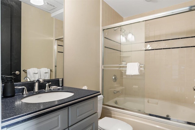 4200 Main St Unit 26, Bay Harbor, MI 49770 - bathroom with shower / bath combination with glass door, toilet, visible vents, and vanity