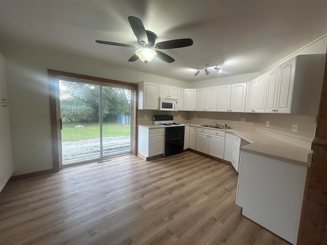 kitchen with ceiling fan, white cabinets, light hardwood / wood-style flooring, and white appliances