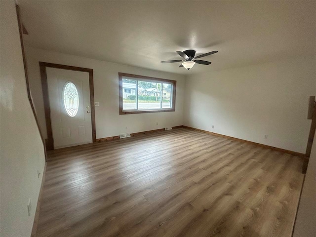 foyer entrance with light hardwood / wood-style flooring, ceiling fan, and plenty of natural light