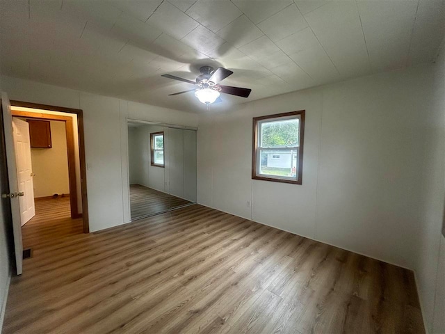 unfurnished bedroom with ceiling fan and hardwood / wood-style flooring