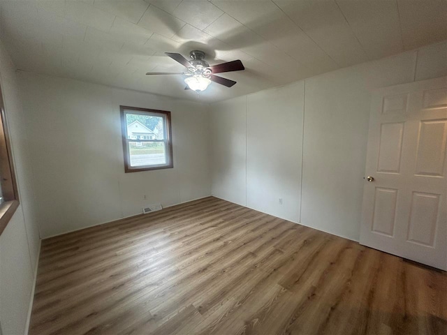 empty room with ceiling fan and hardwood / wood-style flooring