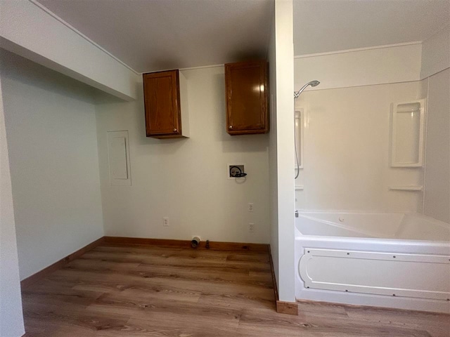 bathroom with hardwood / wood-style floors and a tub