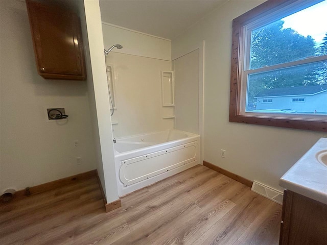 bathroom featuring vanity,  shower combination, and hardwood / wood-style flooring