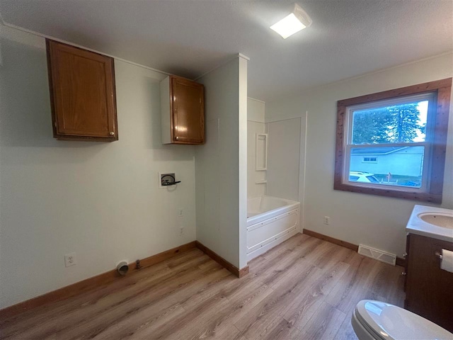 bathroom featuring vanity, hardwood / wood-style floors, toilet, and a textured ceiling