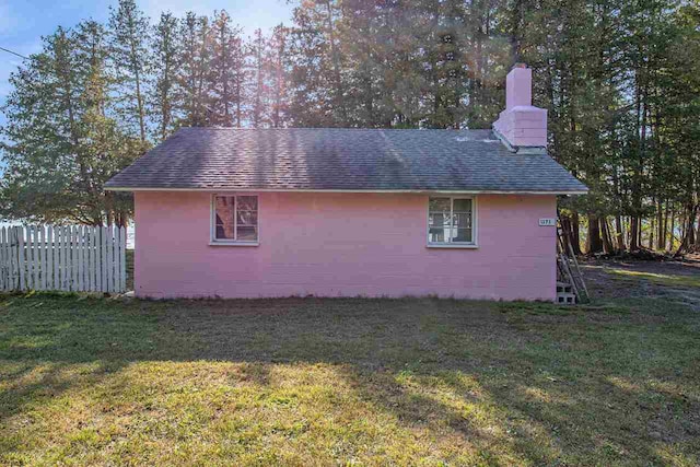 view of side of home with a lawn