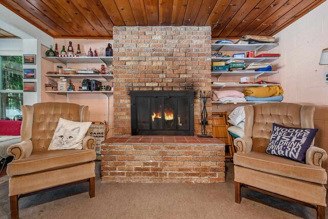 carpeted living room with wooden ceiling and a fireplace