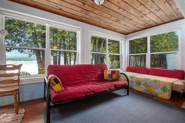 sunroom with wooden ceiling, a water view, and a wealth of natural light