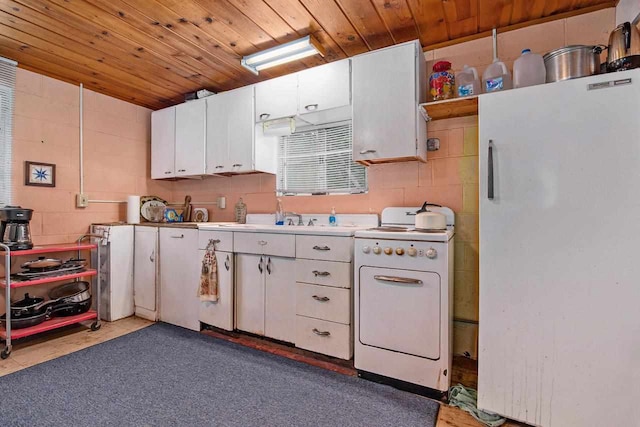 kitchen featuring white cabinetry, sink, wooden ceiling, and white appliances