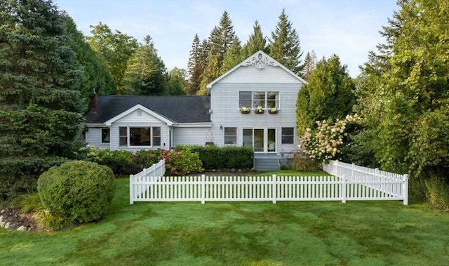 rear view of property with a yard