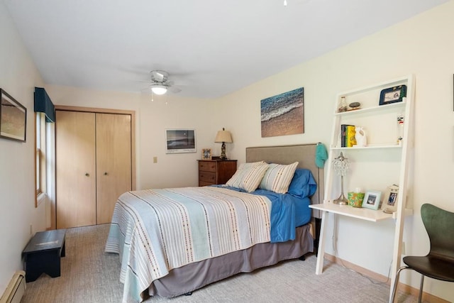 carpeted bedroom featuring ceiling fan, baseboard heating, and a closet