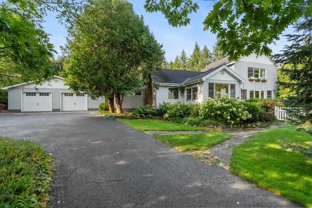 view of front of house featuring a front yard and a garage