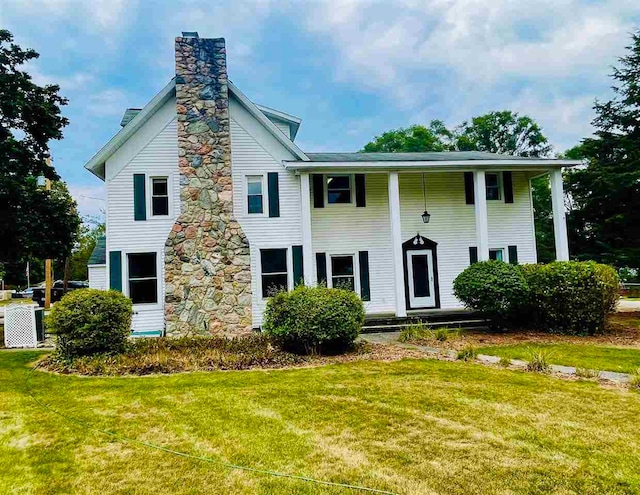 view of front facade with a front lawn and central air condition unit