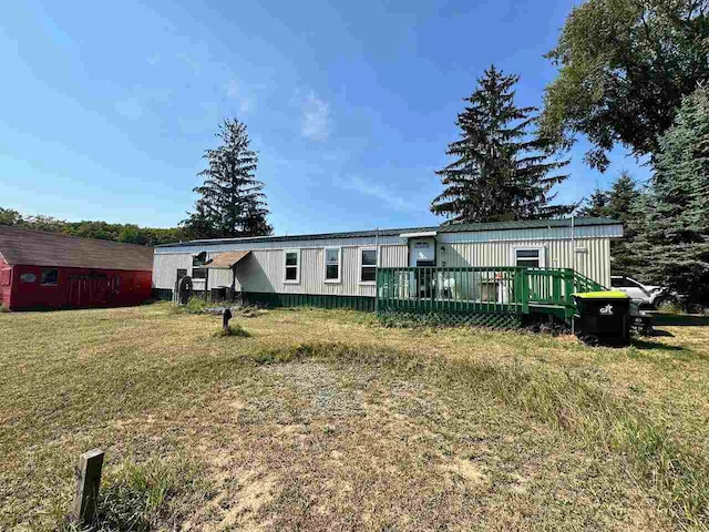 rear view of property featuring a yard