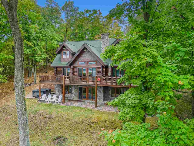 rear view of house featuring a wooden deck