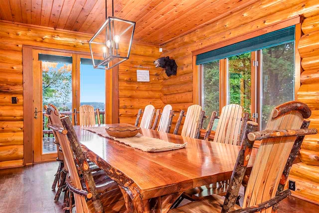 dining space with hardwood / wood-style floors, wooden ceiling, and log walls