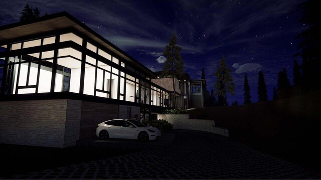 3087 Forrest Ave, Harbor Springs, MI 49740 - property exterior at twilight with stone siding
