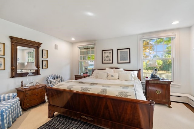 bedroom with multiple windows and light colored carpet